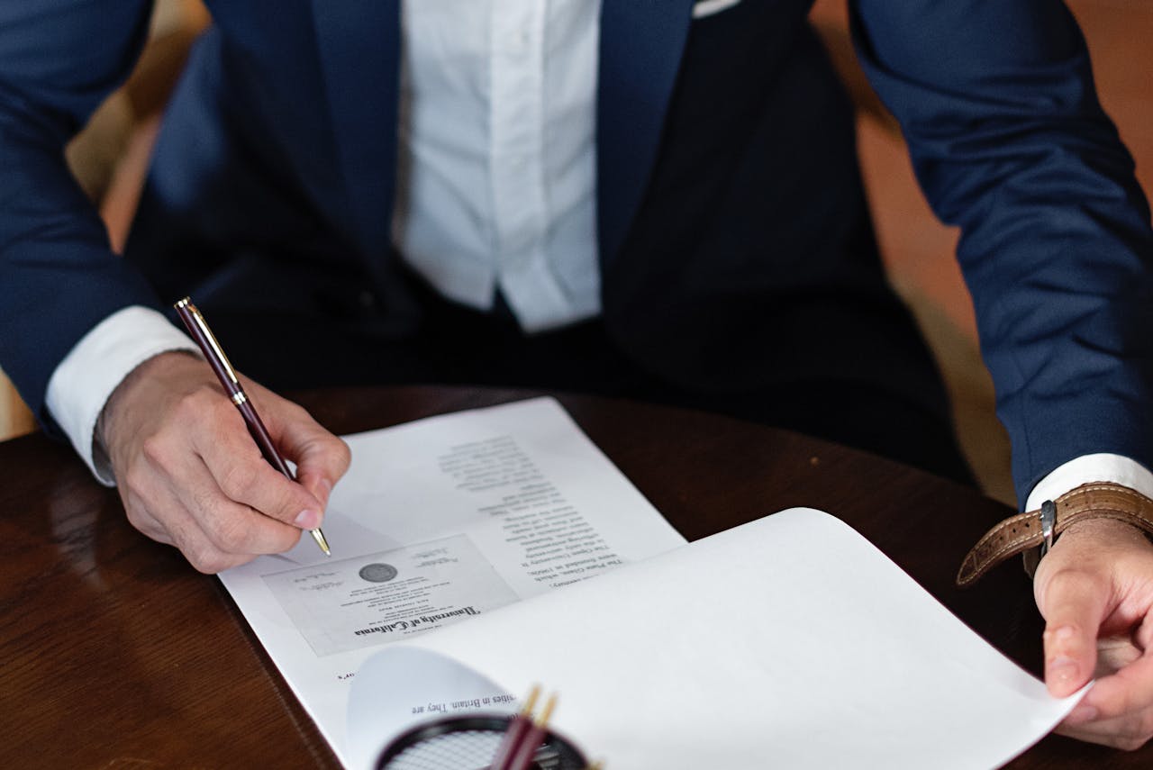 person-signing-documents person-signing-lease-documents